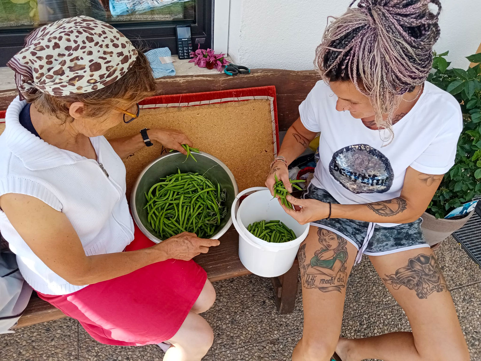Eva and her mother picking beans